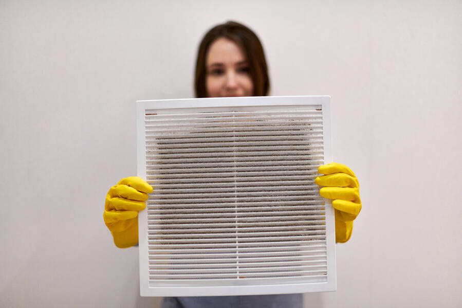 Lady Holding Dirty Vent for Prescription Duct Cleaning